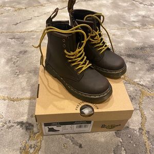 Brown Dr. Martens boots.